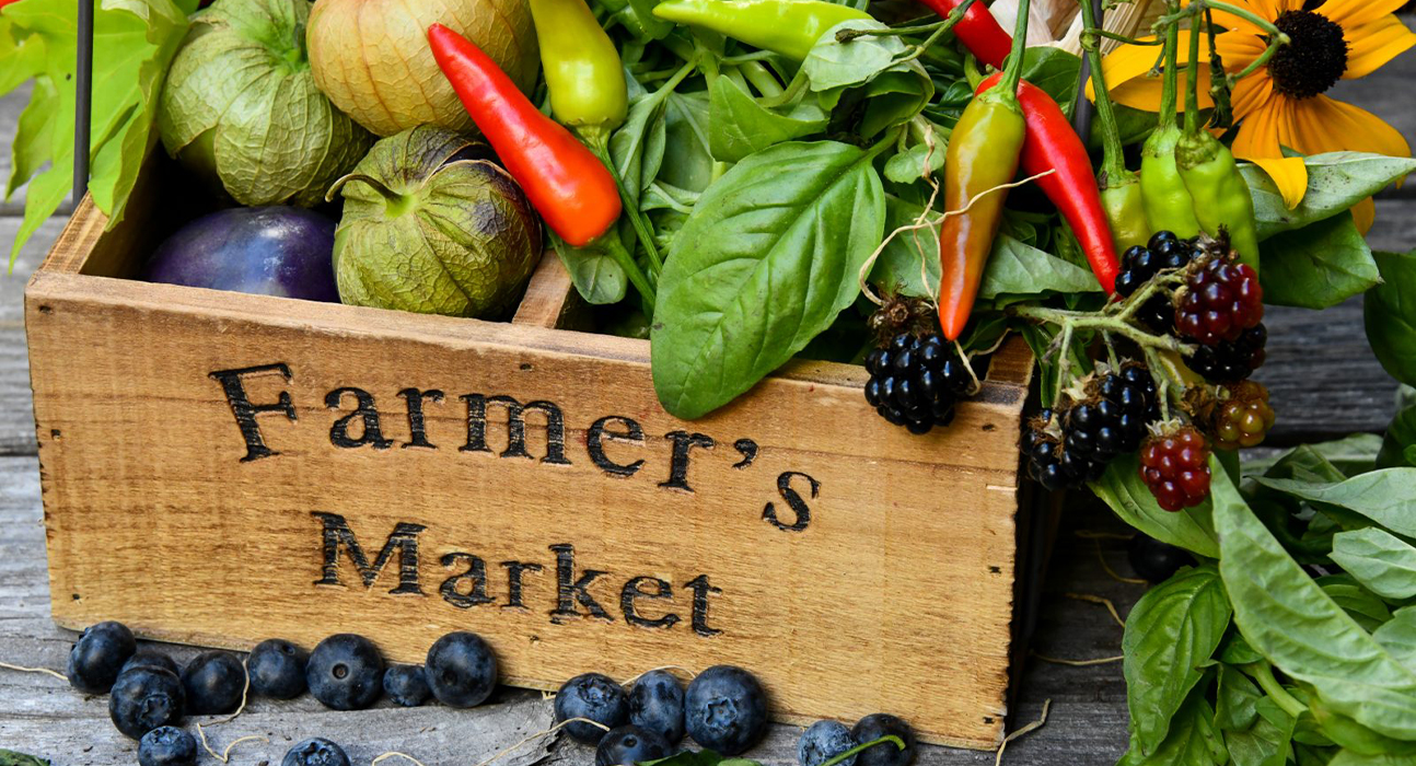 farmers market box with fresh fruit and vegetables inside