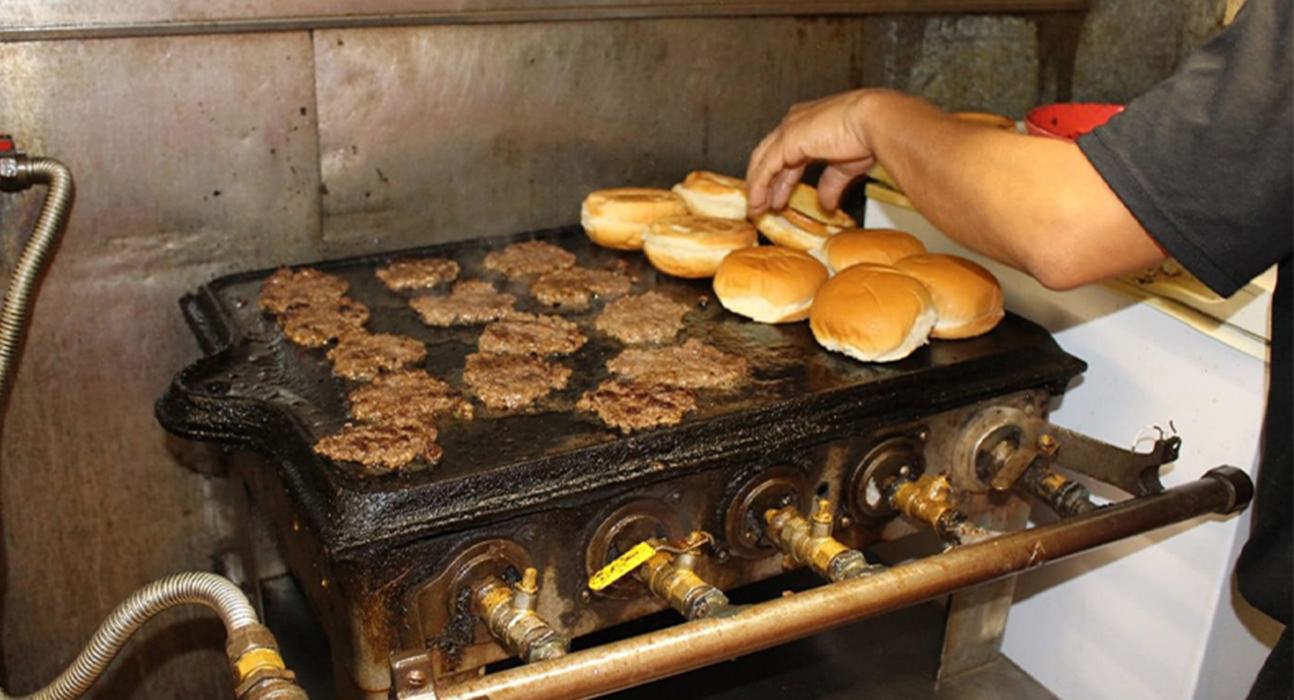 hamburger patties and buns cooking on grill
